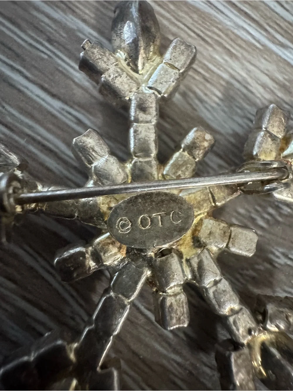 OTC vintage snowflake silver tone brooch with clear gemstones